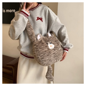 Close-up of grey striped plush cat bag with cute blue eyes and soft faux fur texture