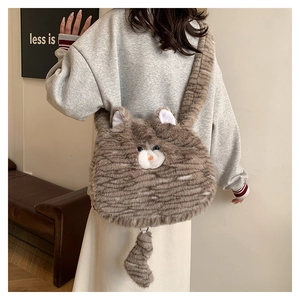 Close-up of cute plush cat-shaped shoulder bag with fuzzy striped texture and tail detail