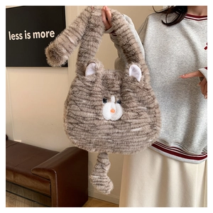 Detail of cute cat shaped plush handbag featuring brown striped faux fur and long tail