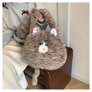 Close-up of cute plush cat bag with fluffy brown stripes and long decorative tail