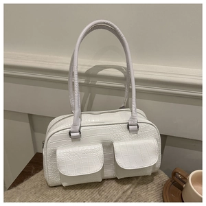 Close-up of white crocodile texture boston bag with dual front flap pockets