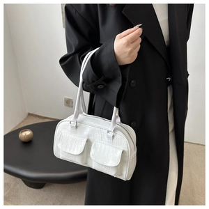 Close-up of white crocodile texture faux leather shoulder bag with double front flap pockets