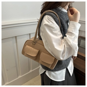 Model showing beige crocodile embossed faux leather shoulder bag with front double pockets