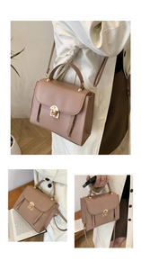 Close-up of elegant mauve faux leather bag featuring golden lock and decorative zippers