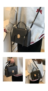 Detail of black crossbody bag with gold twist lock closure and decorative tassels