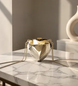 Mini heart-shaped geometric clutch bag in metallic gold and silver with chain strap