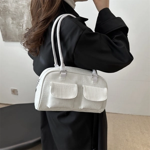 White faux crocodile embossed Boston handbag shown on shoulder with long straps