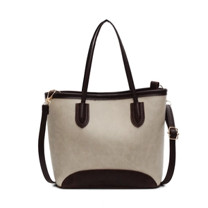 Minimalist beige and brown leather tote bag with top handle and adjustable shoulder strap