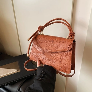 Retro terracotta handbag with embossed lotus pattern and decorative knotted handle