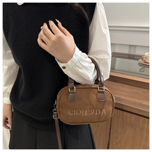 Detail of brown suede crossbody bag with soft texture and CIOH'2DA embroidery