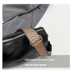 Detail of adjustable patterned wide shoulder strap on a black lychee texture pillow bag