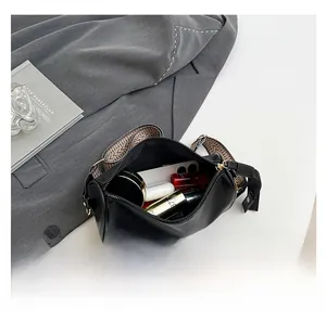Interior view showing large capacity for phone and cosmetics in black leather crossbody bag
