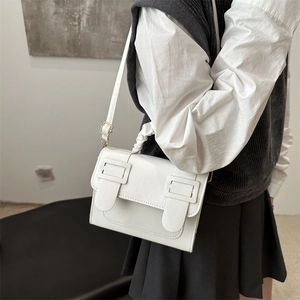 Chic white glossy PU leather crossbody bag with pleated handle and decorative straps