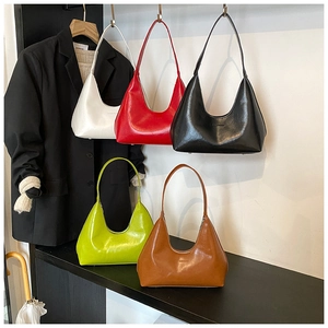 Multiple colors of semi-circular armpit bags in white, red, black, green and caramel leather
