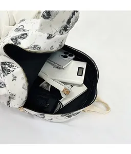 Interior view showing the large capacity of the white butterfly print backpack with metal zip