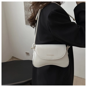 Detail of white leather shoulder bag with wavy bottom and FASHION & BAGS lettering