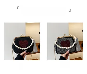 Detail view of heart-shaped rhinestone evening bags in black and white with pearl handles