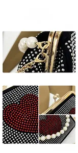 Detail of vintage black clutch with heart rhinestones, pearls and golden kiss lock