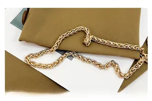 Detailed view of the bright gold braided metal chain with premium metallic texture