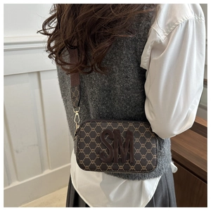 Detail of vintage square crossbody bag with SM logo and wide fabric shoulder strap