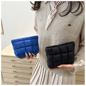 Quilted waterproof nylon cosmetic bags in royal blue and black with padded grid design
