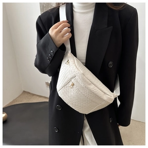 Close-up of white woven leather chest bag featuring premium gold metal zippers