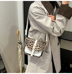 Detail of leopard print patchwork shoulder bag with white PU base and adjustable strap