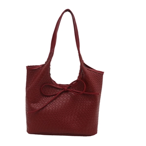 Deep red woven tote bag with slim leather bow detail for casual daily use