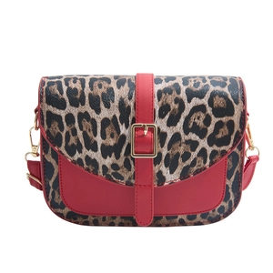 Chic saddle shoulder bag with red leather and leopard print paneling and gold hardware