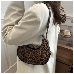 Close-up of leopard print crescent bag on model with vintage aesthetic style