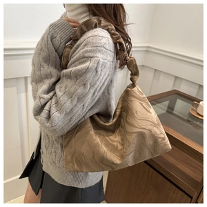 Detail view of coffee and beige marble print tote with pleated cloud shoulder strap