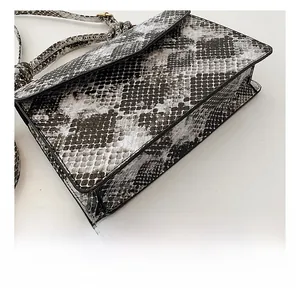 Close-up of the wear-resistant flat base on the faux snakeskin leather crossbody bag