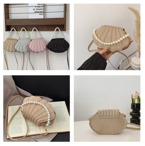 Detail of shell-shaped crossbody bag with pearl handle and textured metallic finish