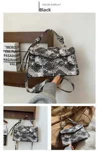 Detail of snake print crossbody bag with knotted handle and monochrome pattern