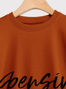 Close-up of caramel cotton sweatshirt with ribbed crew neck and Expensive print