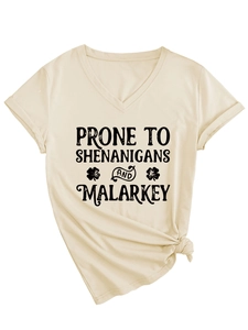 Detail of V-neck T-shirt with shenanigans slogan, clover print, and front hem knot