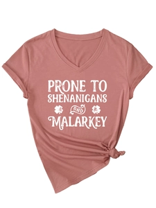 Detail of V-neck T-shirt in dusty rose with white slogan print and side knot design