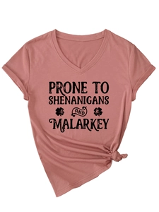 Detail of V-neck pink t-shirt with shenanigans text and a side knot at the hemline