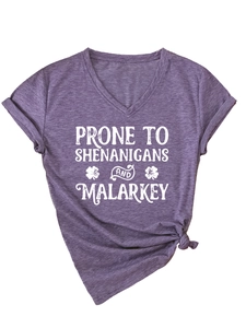 Detail of V-neck purple T-shirt with shenanigans text print and side knot design