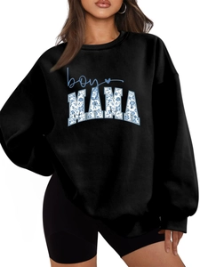 Detail of the boy MAMA floral lettering on a black oversized long sleeve sweatshirt