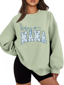 Detail of sage green sweatshirt featuring floral MAMA and blue boy lettering print
