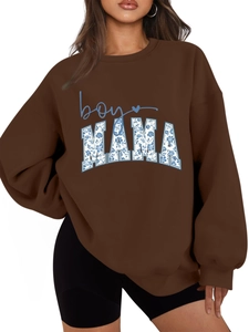Detail of the boy MAMA graphic print on a brown oversized long sleeve sweatshirt