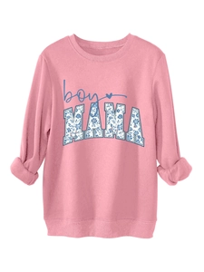 Detail of pink crewneck sweatshirt featuring floral patterned boy MAMA print text