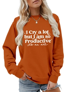 Terracotta crewneck sweatshirt detail featuring white artistic text print on fabric