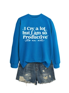 Detail of royal blue crewneck sweatshirt with white printed lettering and denim shorts