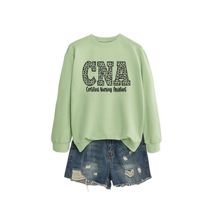 Sage green CNA Certified Nursing Assistant sweatshirt paired with denim shorts for women