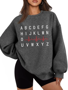 Detail of dark gray oversized sweatshirt with white letters and red heartbeat graphic print