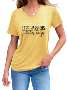 Detail of V-neck ginger yellow t-shirt with Life Happens Pilates Helps graphic print