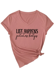 Detail of pink V-neck Pilates T-shirt with 'life happens' print and knotted hem
