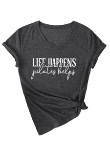Detail of V-neck grey t-shirt with Life Happens Pilates Helps slogan and side-tie knot